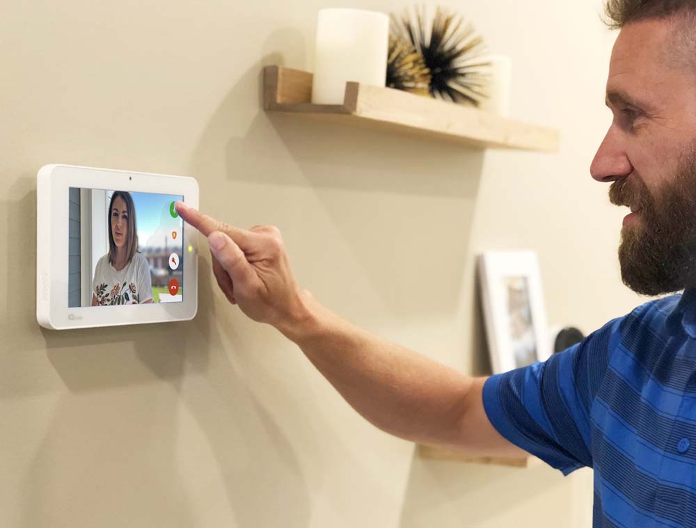 A man looking at the doorbell screen