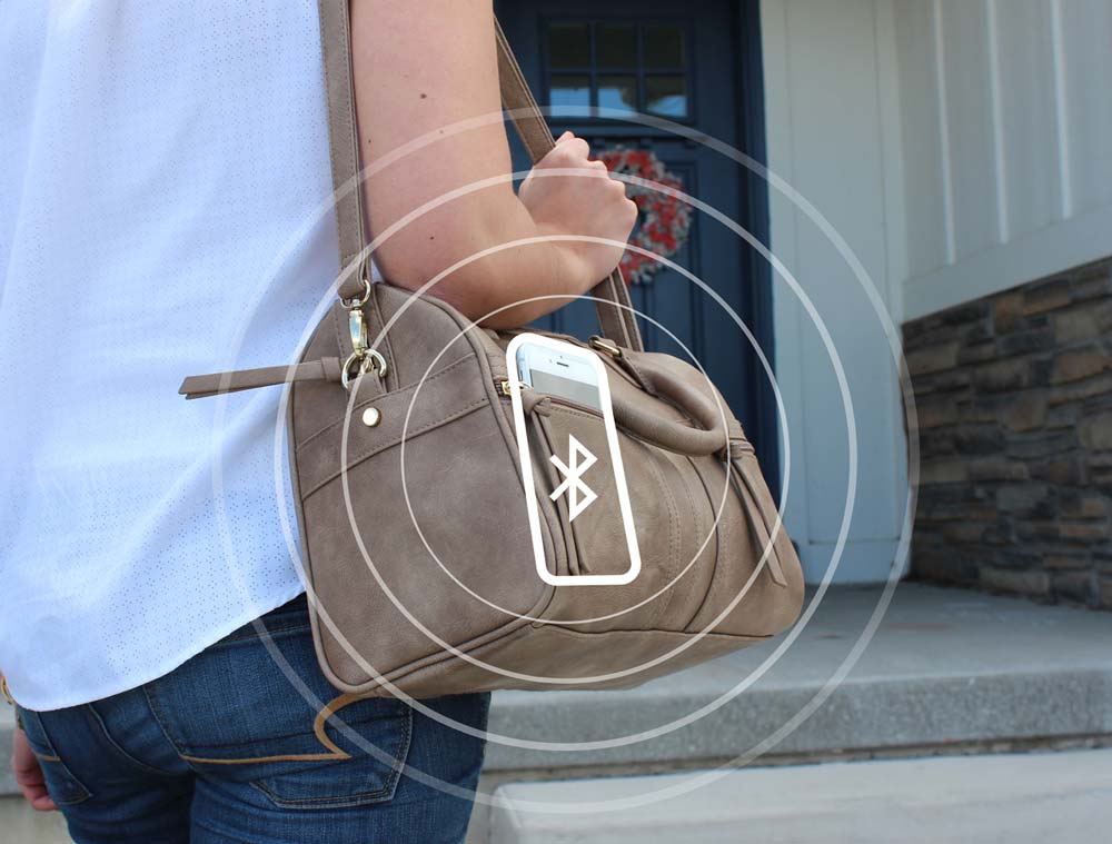 A person with a brown leather shoulder bag