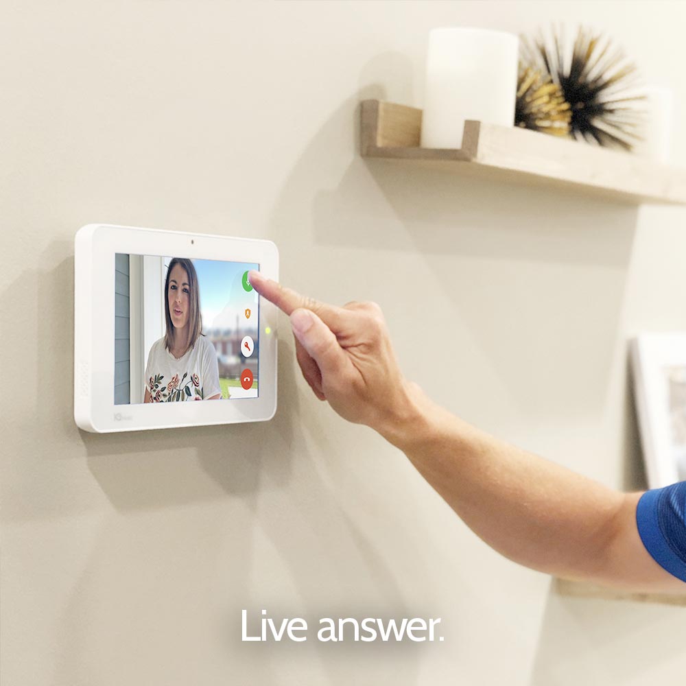A person is pointing at a live answer device on a wall.