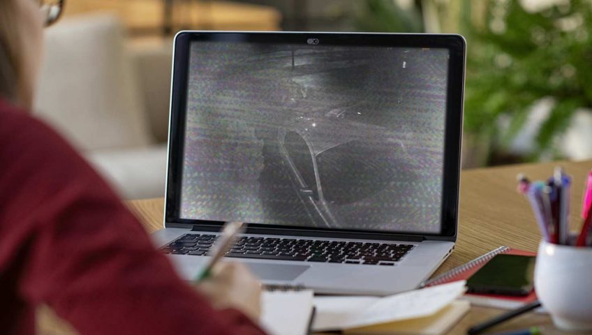 A person looking at the screen of the laptop