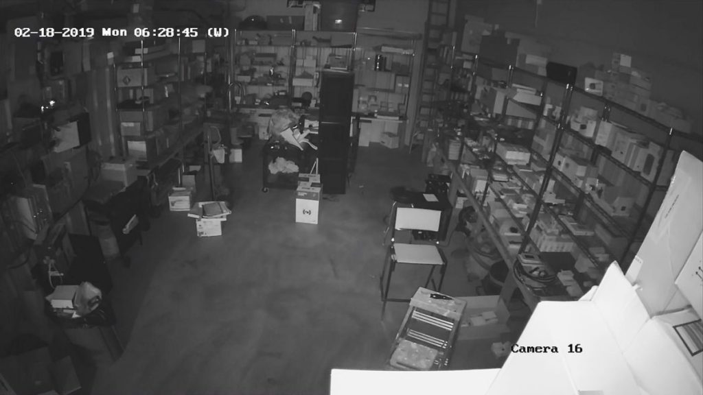 A surveillance camera captures a man in a store.